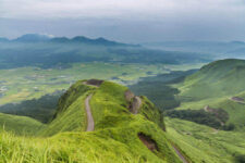 Aso volcano mountain and farmer village in Kumamoto, Japan = Shutterstock