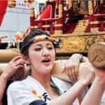 Facial shot of unidentified young women worshipping the golden shrine in Tenjin Matsuri, Osaka's biggest festival = Shutterstock