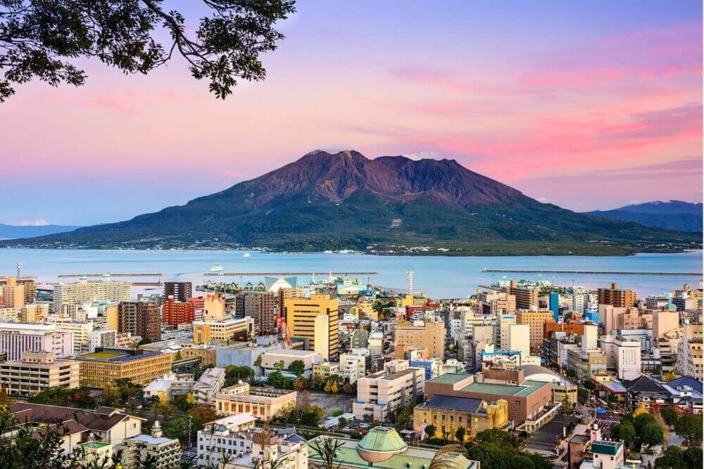Kagoshima, Japan with Sakurajima Volcano = Shutterstock