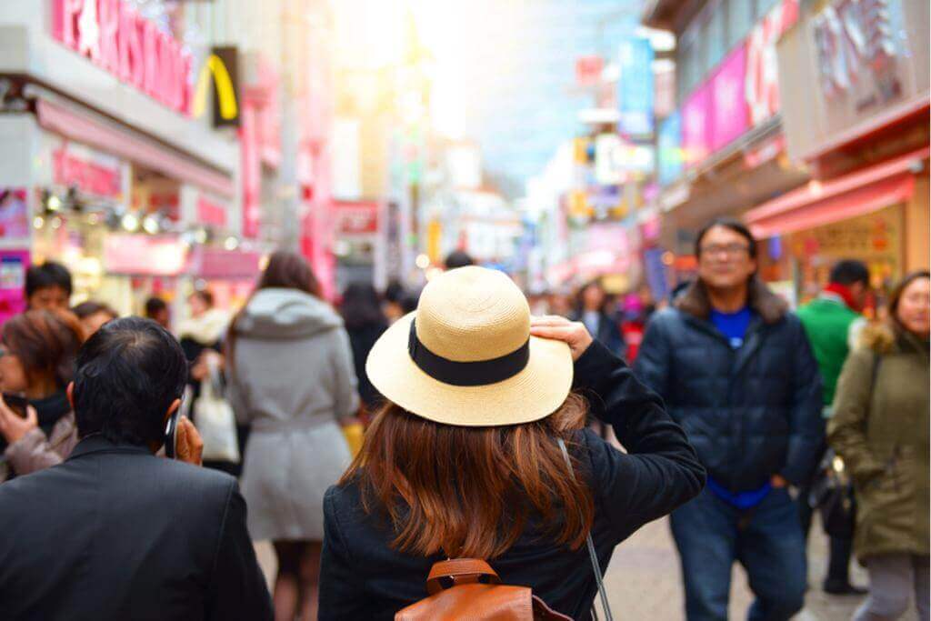 On February, asian woman is enjoy traveling at Harajuku street market in Tokyo, Japan = Shutterstock