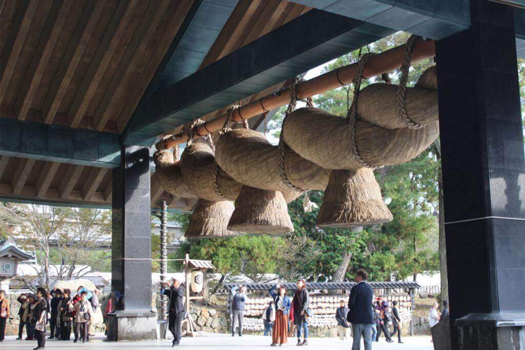 People attending grand shinto shrine Izumo Taisha, Izumo, Japan = Kononchuk Alla / Shutterstock