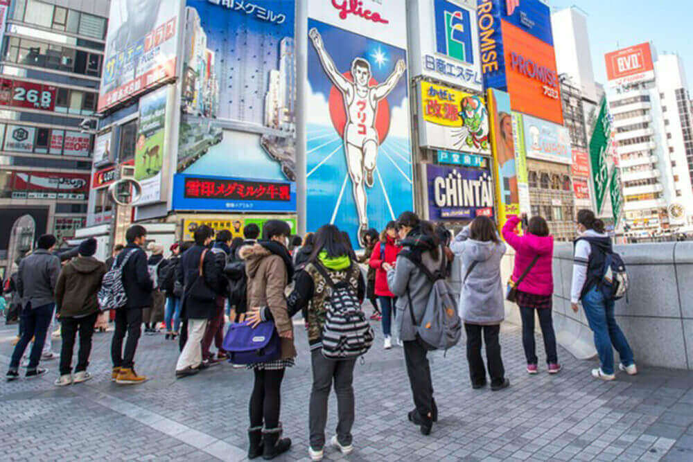 The Glico Man billboard and other light displays at Dontonbori, Namba Osaka area, Osaka, Japan. Namba is well known as an entertainment area in Osaka = Shutterstock