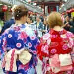 Young girl wearing Japanese kimono standing in front of Sensoji Temple in Tokyo, Japan = Shutterstock