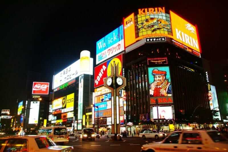 Susukino junction with landmark of Nikka banner advertisement. Night scene of commercial buildings located at Susukino district
