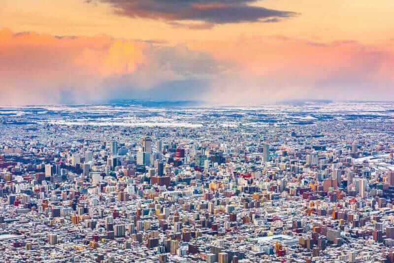 winter skyline view of Sapporo from the mountains at dusk = shutterstock