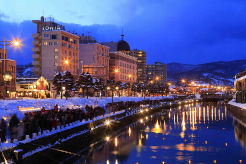 Otaru light path snow festival with lighting and candles light reflection over Otaru canal = shutterstock