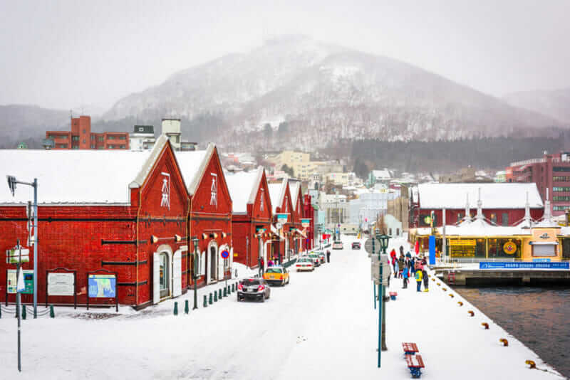 Tourists enjoy a snowy day at historic Kanemori warehouse district. Hakodate Port was among the first Japanese ports to be opened to international trade = shutterstock