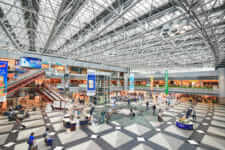 Wide view of New Chitose Airport with travelers and people = shutterstock