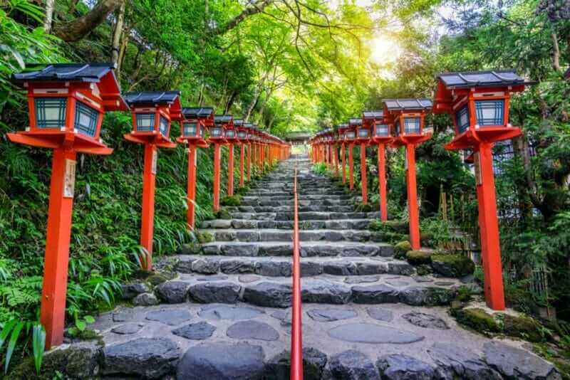 The red traditional light pole at Kifune shrine, Kyoto in Japan = shutterstock