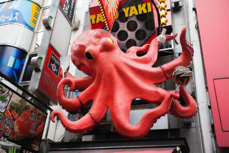Dotonbori Konamon Museum with its huge octopus sign on DEC 1, 2015 in Osaka, Japan. It's where people can learn about the history of konamon and enjoy freshly made takoyaki = shutterstock