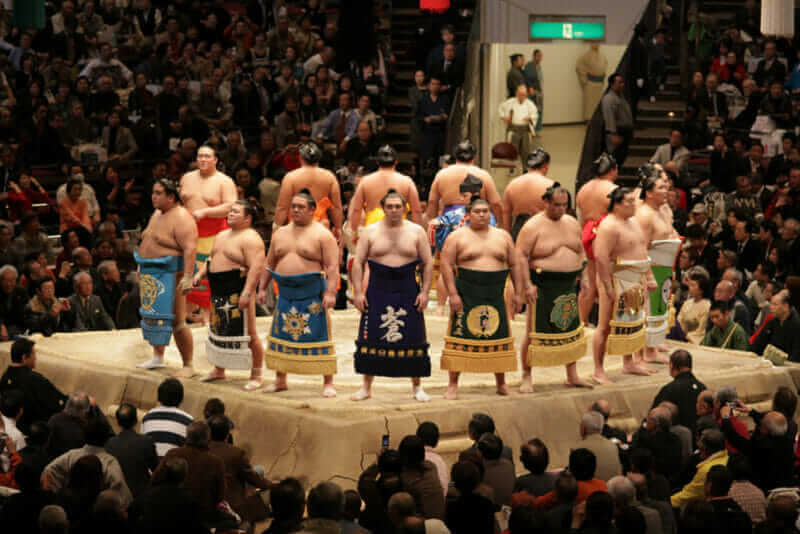High rank sumo wrestlers line up with crowd in the Tokyo Grand Sumo Tournament = shutterstock