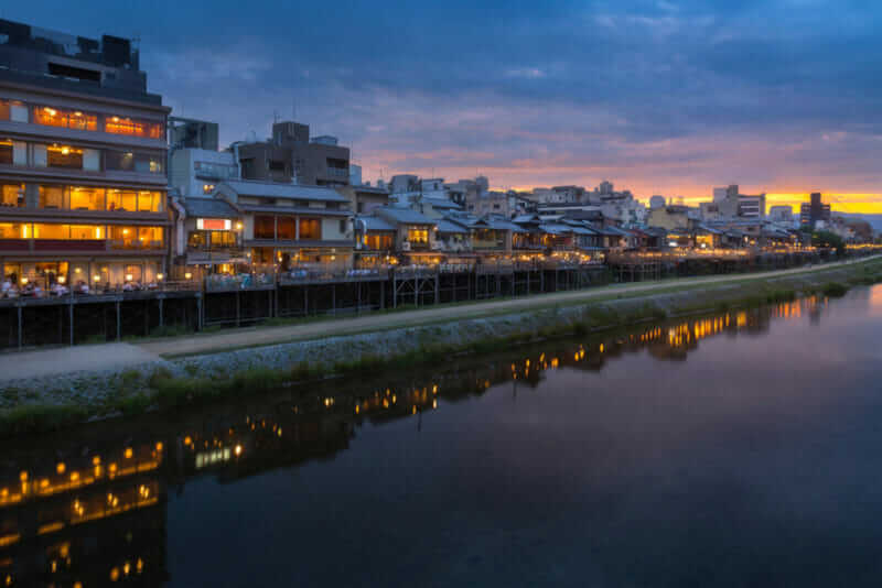 Old house and restaurant in Kamo river or kamogawa river at sunset, Gion, Kyoto, Japan = shutterstock