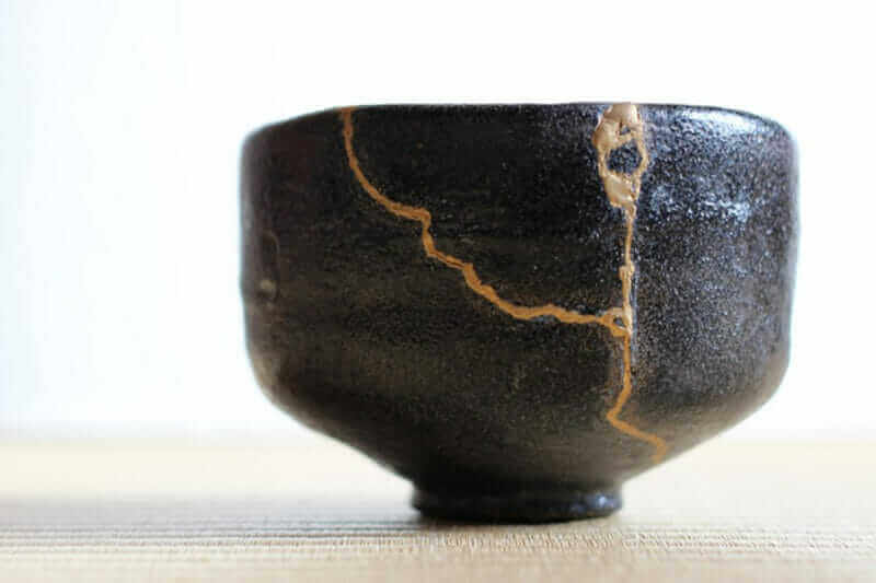 Repair of crack pottery tea cup = shutterstock
