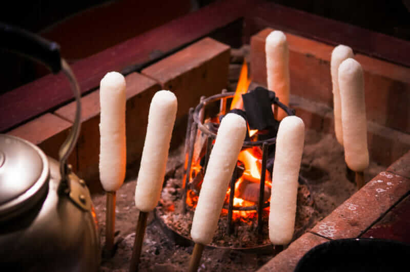 Charcoal grilled Kiritanpo (rice stick), Local food of Akita, Tohoku, Japan = shutterstock