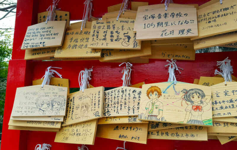 The lovely characters and hope words that be drawn on the wish wooden plate, hanging in the Suga Shrine = shutterstock