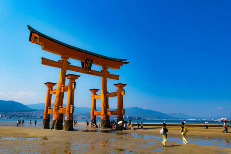 At low tide, you can walk to floating Torii gate, Itsukushima shrine, Miyajima, Japan = AdobeStock