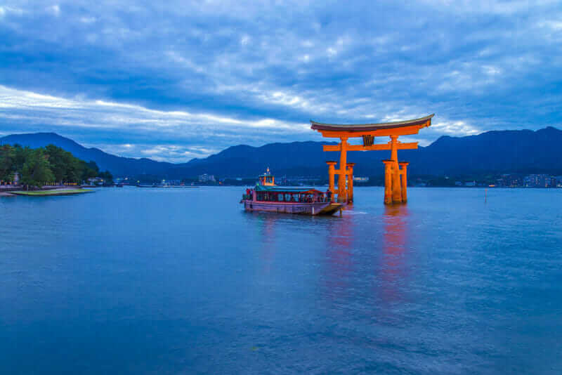 The infamous floating Torii gate of Itsukushima shrine temple in Miyajima, Japan = AdobeStock