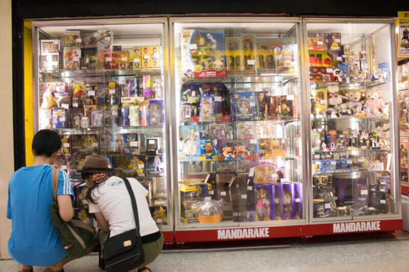 Visitors look at toys on display at Nakano Broadway, Tokyo, Japan = shutterstock