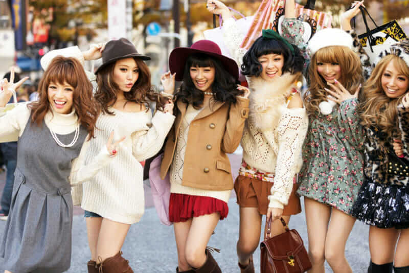 A group of girls is posing in the middle of the street for fashion advertising in the street near the Shibuya crossroad in Tokyo, Japan = shutterstock