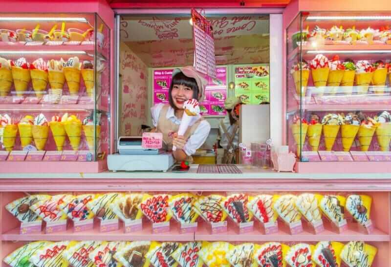 Crape and ice cream vendor at Harajuku's Takeshita street, known for it's Colorful shops and Punk Manga = shutterstock