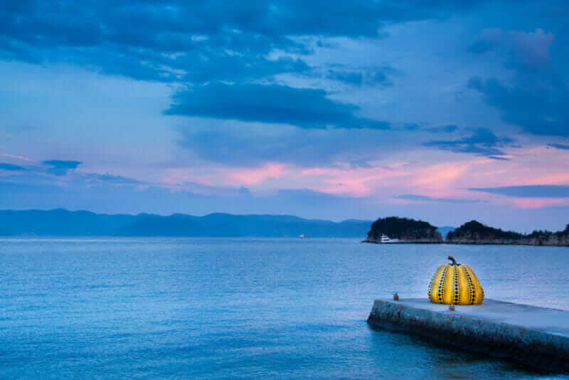 Giant pumpkin objects by Yayoi Kusama that exist in Naoshima. Naoshima is a famous island that there is a lot of art = shutterstock