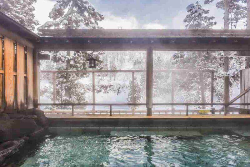 Smoky Outdoor Onsen (Hot Spring) With Snow in Winter at a Ryokan of Zao Onsen, Yamagata , Japan = shutterstock