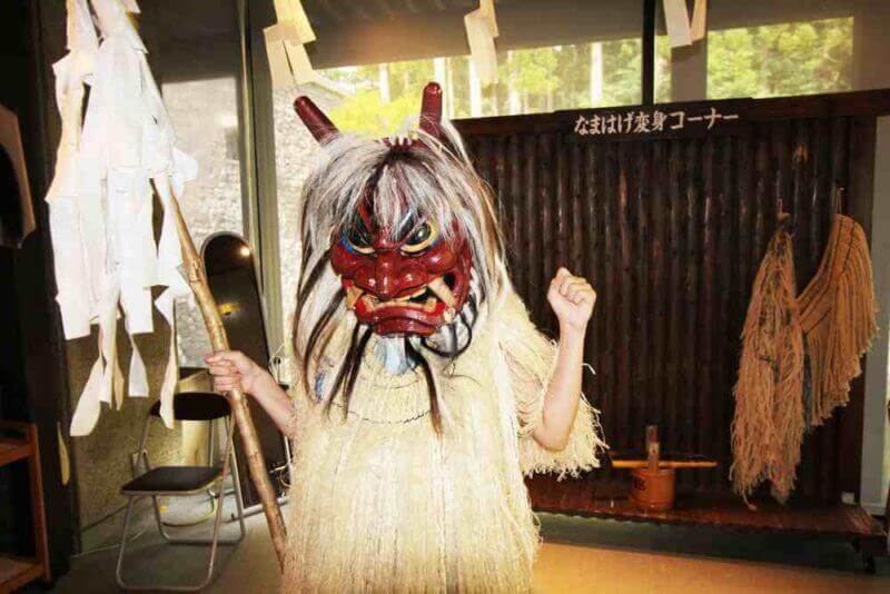 Foreign tourist with Namahage costume in Oga city of Akita Prefecture,Japan. The Namahage is name of giant demon in traditional Japanese folklore and becomes symbol of Akita = shutterstock