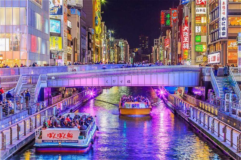 Tourist walking in night shopping street at Dotonbori in Osaka City, Japan = shutterstock