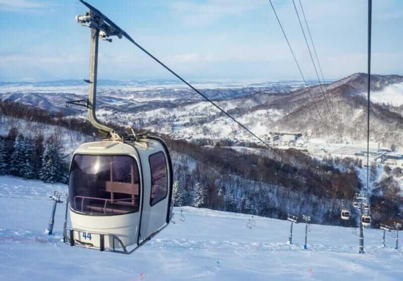 The groomed ski slope and the gondola In Yubari city in Hokkaido, Japan = shutterstock