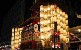 Float at Yoiyama parade with illuminated lanterns, Gion matsuri festival = Shtterstock