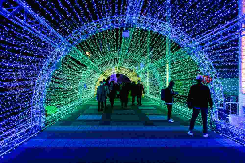 February 2018 : The tourists took a walk and and shot in the led tunnel light with happiness at Tempozan Osaka Bay, Osaka, Japan = Shutterstock