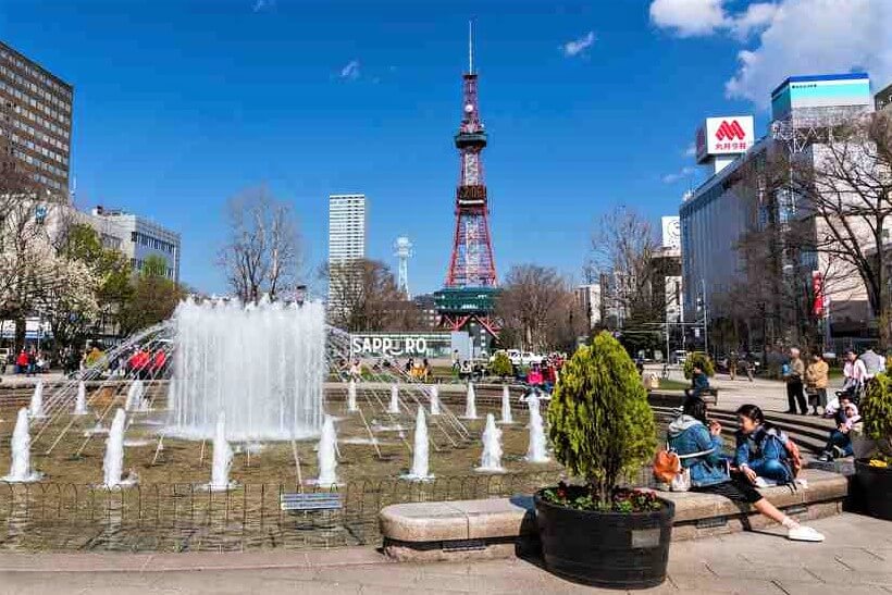 APRIL 24, 2016: Unidentified people at the Fountain of Odori park in front of Sapporo TV tower, Sapporo, Hokkaido = Shutterstock