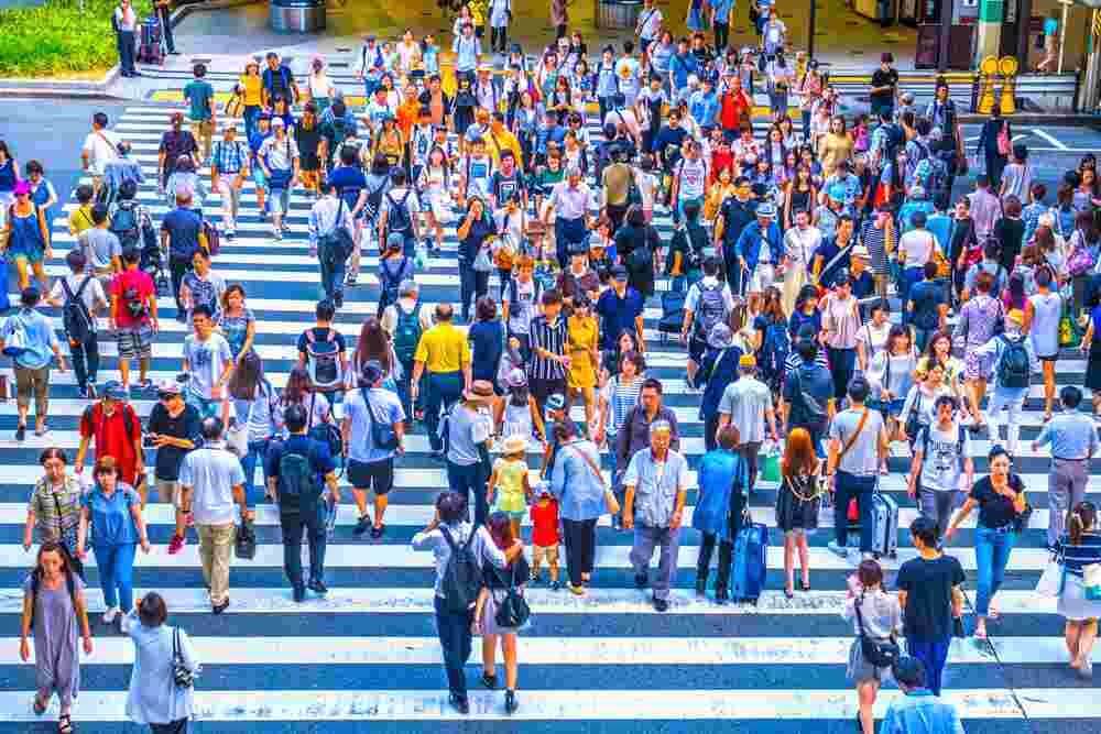 12 August 2018 - People walking crosswalk at Umeda in Osaka,Japan = Shutterstock