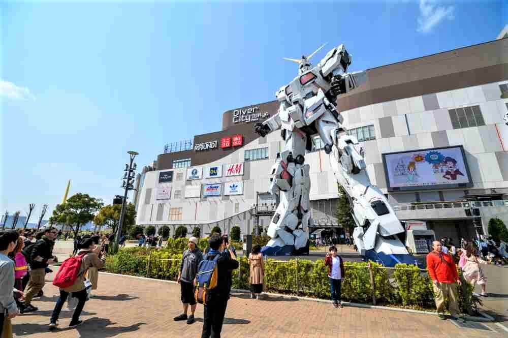 May 23, 2019 : Odaiba real-size Unicorn Gundam statue model in front of Diver City plaza Tokyo in Odaiba, Japan = Shutterstock