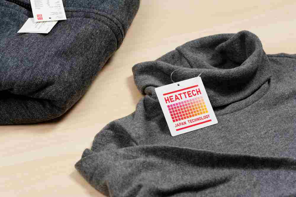 Closeup HEATTECH tag on Uniqlo product. HEATTECH provides thermal insulation by converting the vapor generated by the body into heat