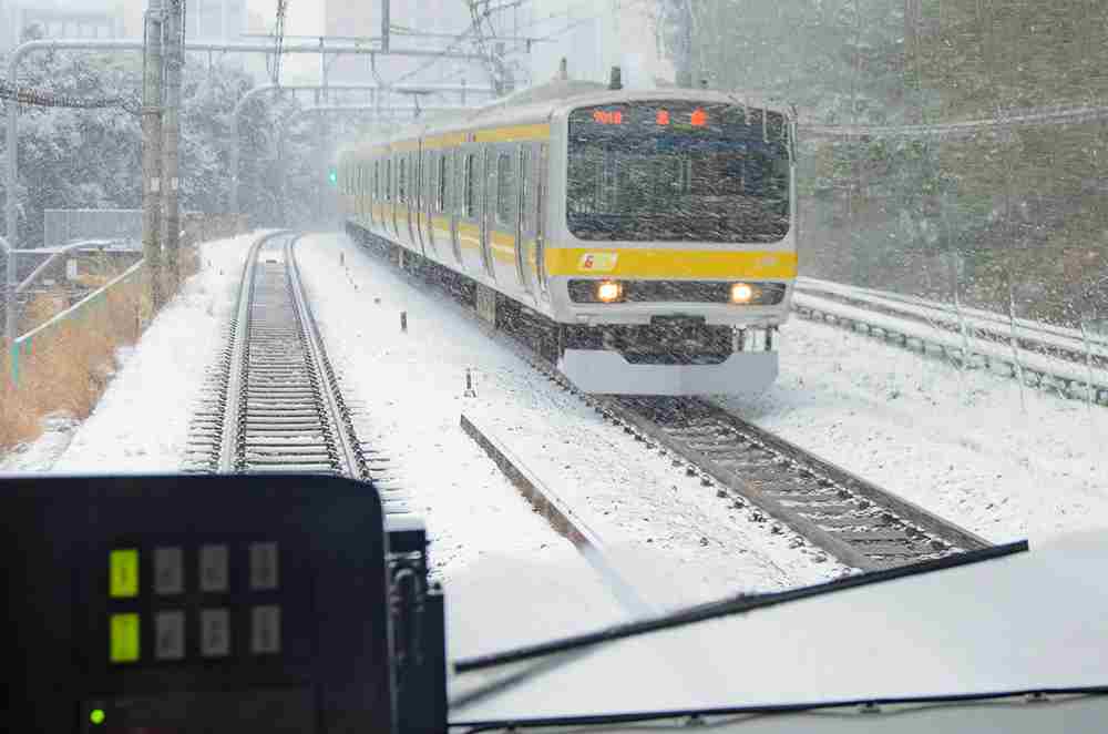 February 8, 2014 train speeding through the snow in Tokyo, Japan = Shutterstock