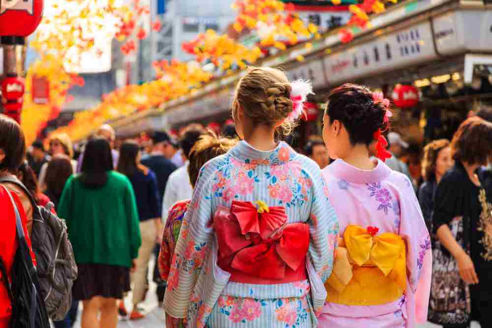 October 21, 2016: unidentified foreigner tourist wearing kimono, the national tradition costume of Japan walking at Sensoji temple the famous temple in Tokyo, Japan = Shutterstock