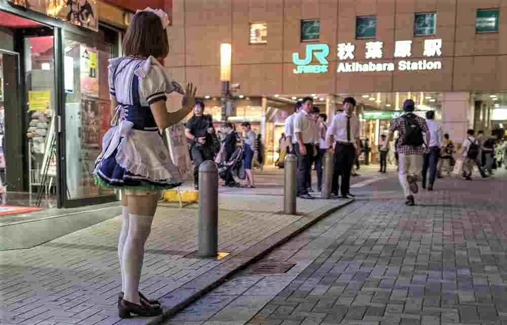 SEPTEMBER 21ST, 2017. Japanese in maid dress trying to entice customers into maid cafe in Akihabara, Tokyo, Japan = Shutterstock