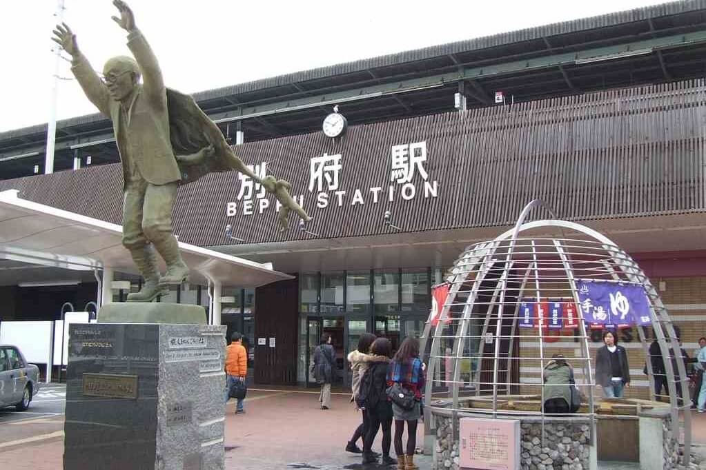 Beppu Japan Railway Station with Statue of Kumahachi Aburaya or the shiny uncle Located in front of Beppu train station