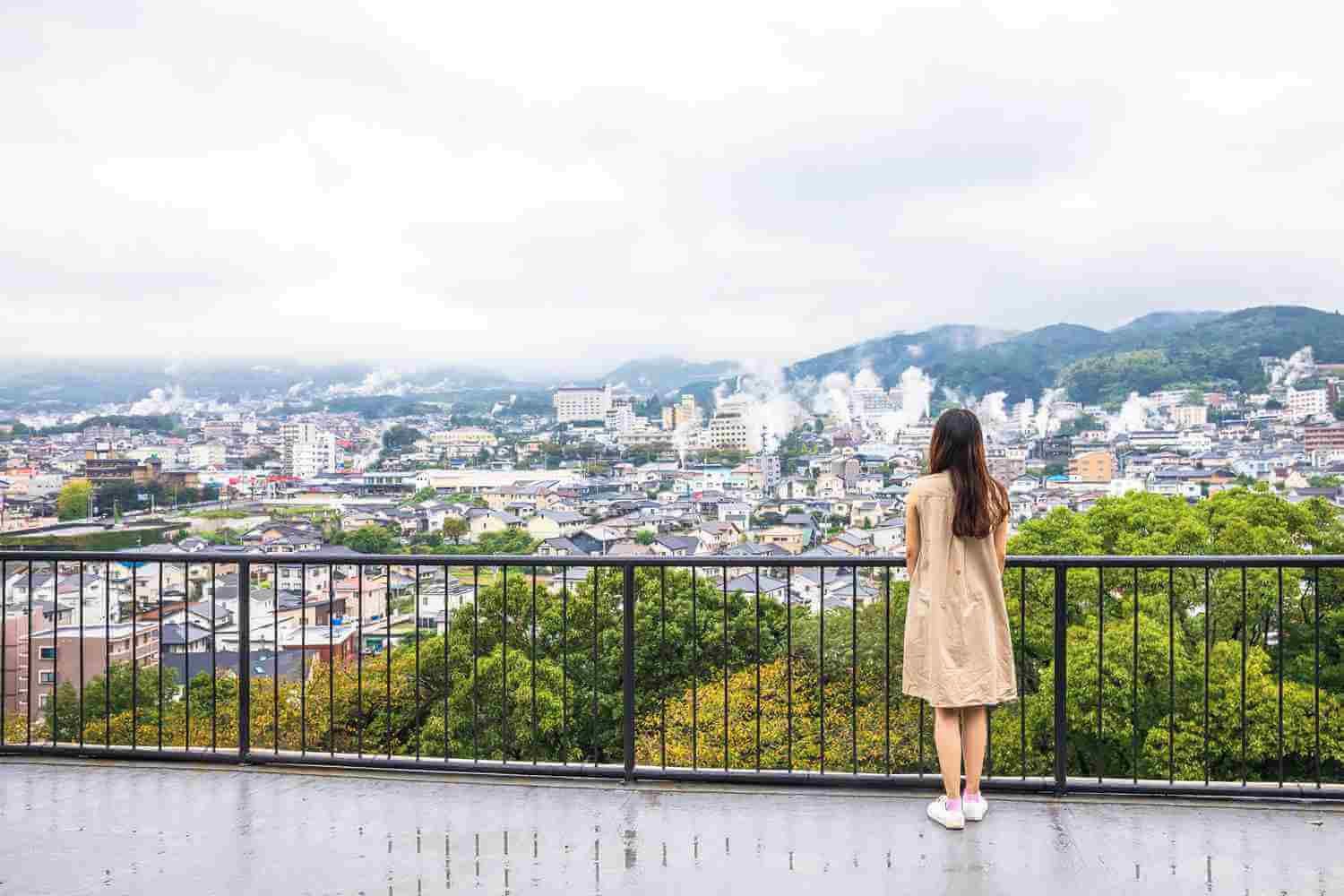  Female tourists at the viewpoint of Beppu, Japan's No. 1 hot spring town, a city with Steam drifted from public baths and ryokan onsen