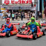 cosplayers driving mario karts at tokyo streets = Shutterstock