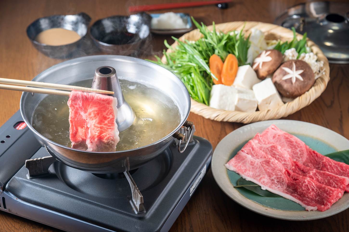 In shabu-shabu cooking, we put thinly sliced beef into boiling water instantaneously before eating it = Shutterstock