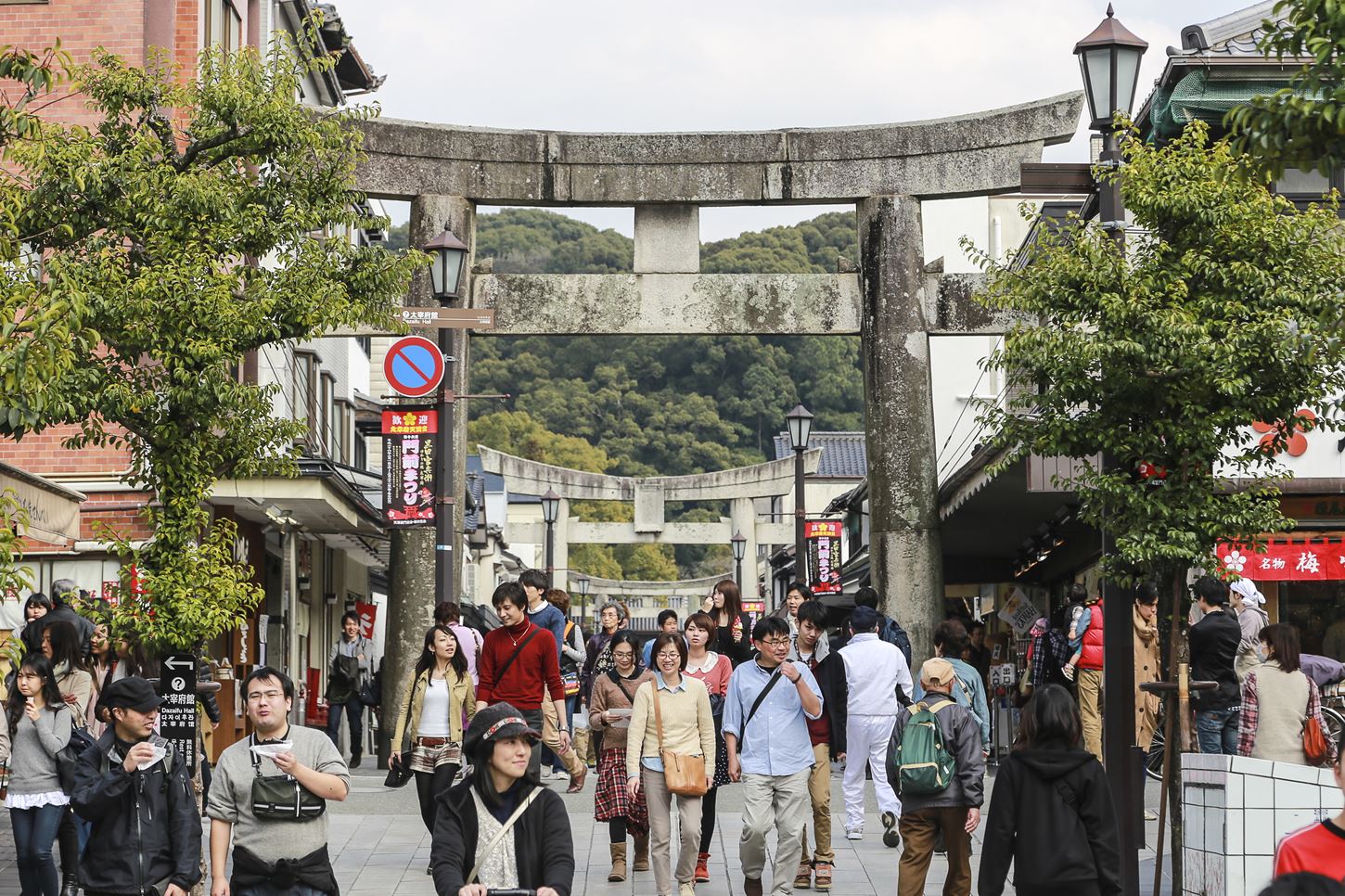 Many Tourists are walking pass the Torii gate of Dazaifu tenmangu shrine ,The most famous and ancient in Fukuoka, Japan = Shutterstock